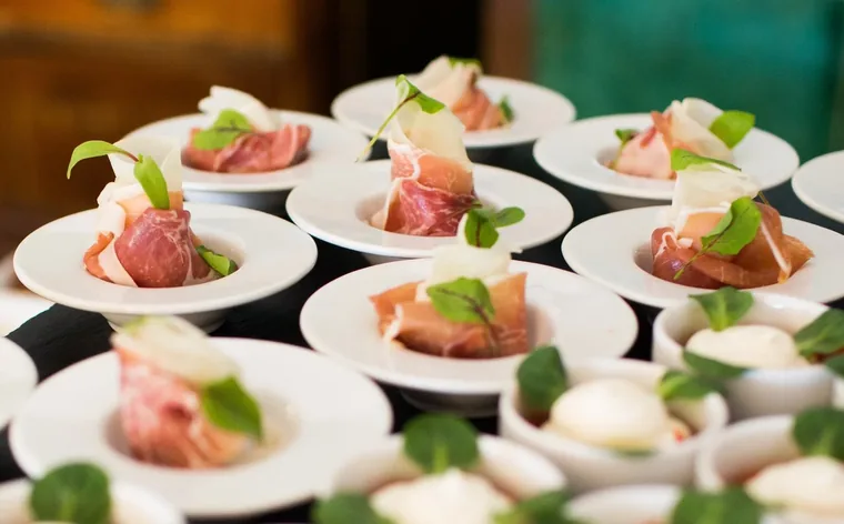 Plated appetizers laid out for a catered event